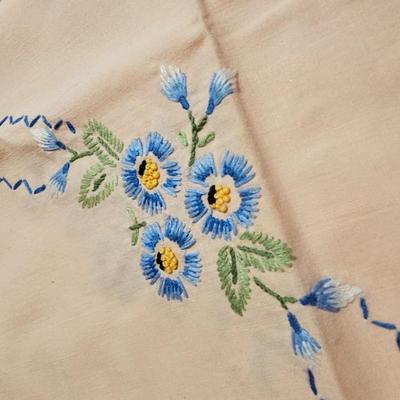 Vintage embroidered kitchen linens and a Royal eight-inch expandable trivet