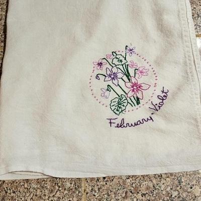 Vintage embroidered kitchen linens and a Royal eight-inch expandable trivet