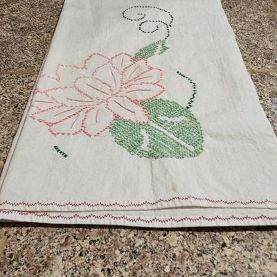Vintage embroidered kitchen linens and a Royal eight-inch expandable trivet
