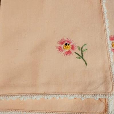 Vintage embroidered kitchen linens and a Royal eight-inch expandable trivet