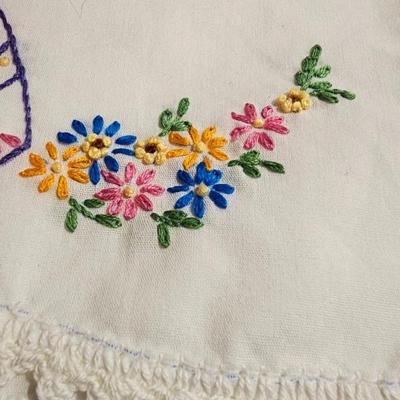 Vintage embroidered kitchen linens and a Royal eight-inch expandable trivet