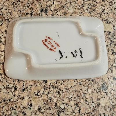 Vintage embroidered kitchen linens and a Royal eight-inch expandable trivet