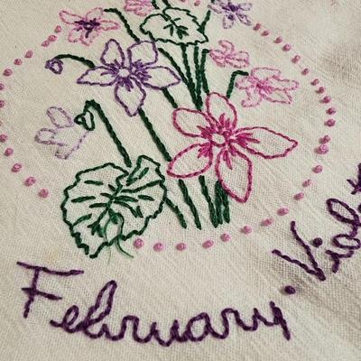 Vintage embroidered kitchen linens and a Royal eight-inch expandable trivet