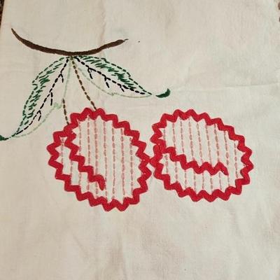 Vintage embroidered kitchen linens and a Royal eight-inch expandable trivet