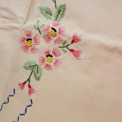 Vintage embroidered kitchen linens and a Royal eight-inch expandable trivet