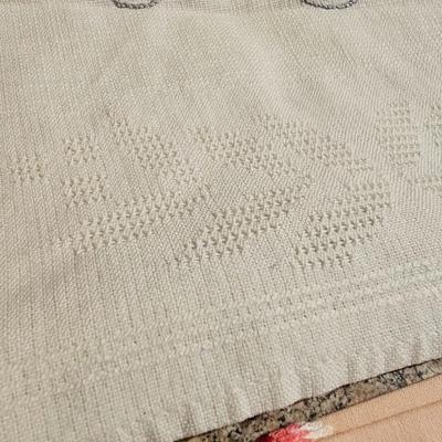 Vintage embroidered kitchen linens and a Royal eight-inch expandable trivet