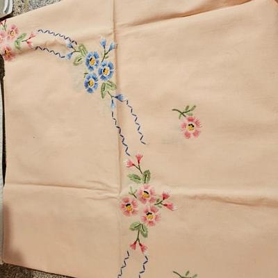 Vintage embroidered kitchen linens and a Royal eight-inch expandable trivet