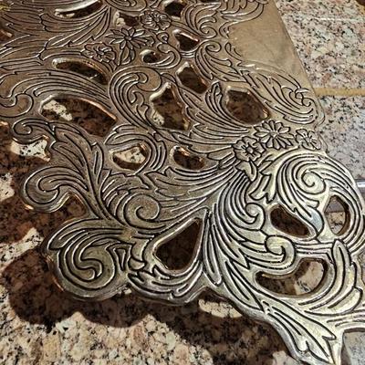 Vintage embroidered kitchen linens and a Royal eight-inch expandable trivet