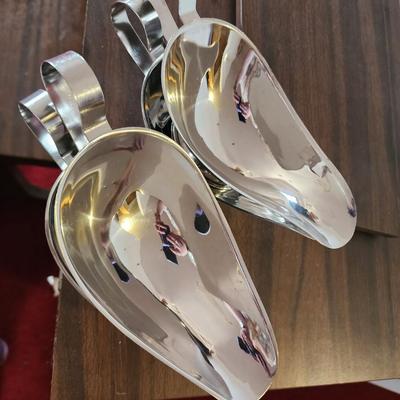 Set of stainless steel gravy boats.