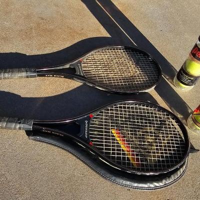 Two tennis racquets with tennis balls