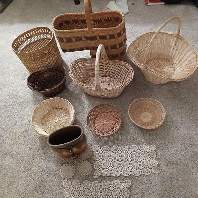 Grouping of wicker baskets and Doilies with pottery vase