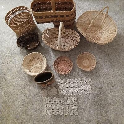 Grouping of wicker baskets and Doilies with pottery vase