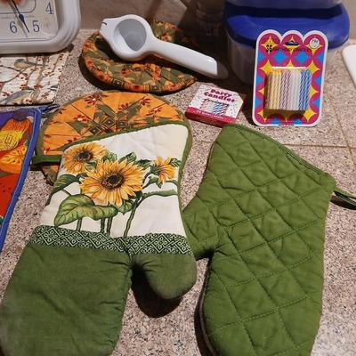 Assortment of Kitchen items - Hot pads - wall clock - plastic food storage and more