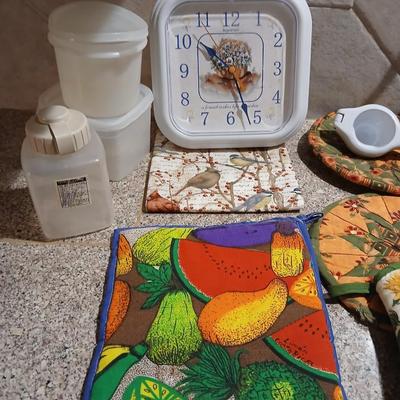 Assortment of Kitchen items - Hot pads - wall clock - plastic food storage and more