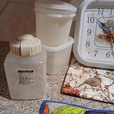 Assortment of Kitchen items - Hot pads - wall clock - plastic food storage and more