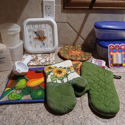 Assortment of Kitchen items - Hot pads - wall clock - plastic food storage and more