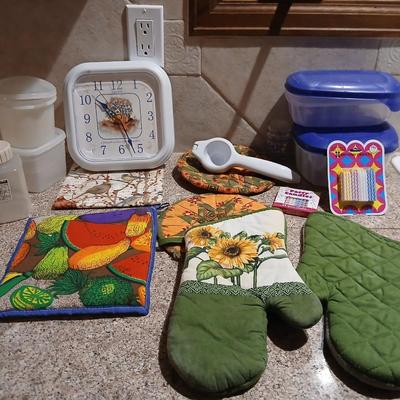 Assortment of Kitchen items - Hot pads - wall clock - plastic food storage and more