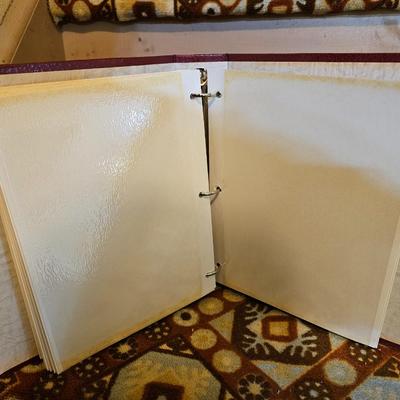 Assortment of framed artwork, picture frames, and photo album books