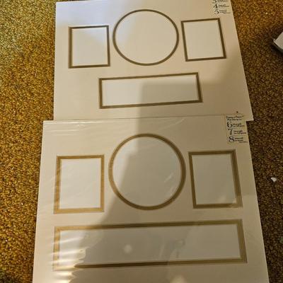 Assortment of framed artwork, picture frames, and photo album books