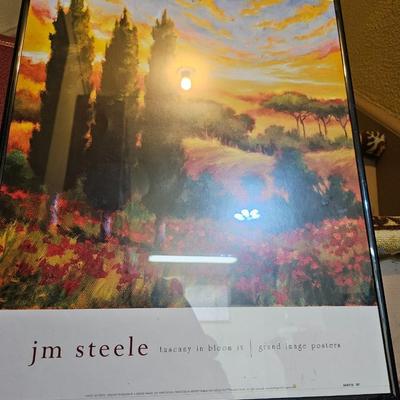 Assortment of framed artwork, picture frames, and photo album books