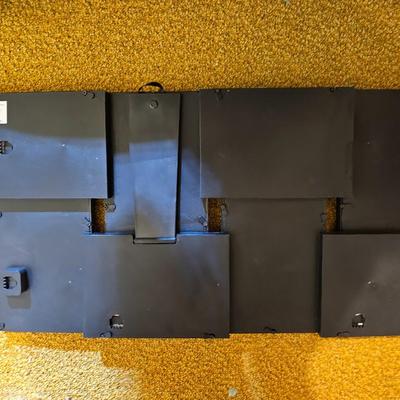 Assortment of framed artwork, picture frames, and photo album books