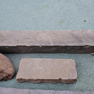 Sandstone edging rocks and a wood landscape stump
