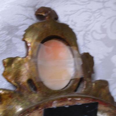 Vintage framed mirror with cameo in the frame
