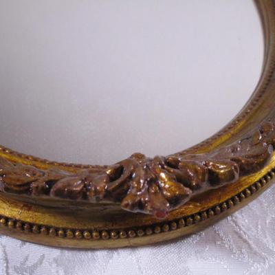 Vintage framed mirror with cameo in the frame