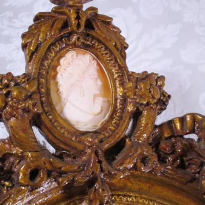 Vintage framed mirror with cameo in the frame