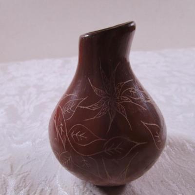 Clay stone-polished vase with flower etching on it