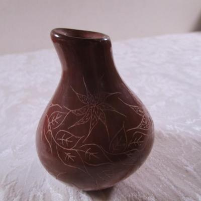 Clay stone-polished vase with flower etching on it