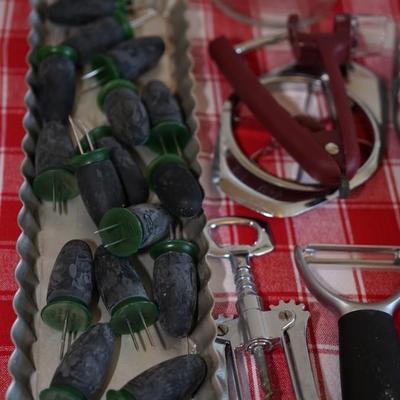 Sale Photo Thumbnail #160: handy items, 
reamer with collection jar
corn holders with heavy duty rubber handles
grouping of plastic scoops
2 cup pyrex measure cup
paper towel holder
glass jar with stainless lid  
quality utensils to include wine opener, apple slider, cheese slicer,