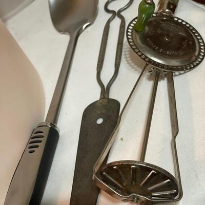 Vintage kitchen utensils and large Tupperware container