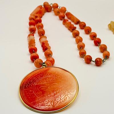 LOT 15: Vintage Orange Onyx Mayan/Aztec Medallion 2 1/4" Pendant on a 24" Long Beaded Necklace and More