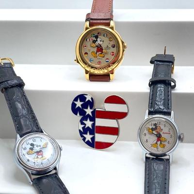 LOT 55J: Three Disney Mickey Mouse (Lorus / Ingersoll) Watches and One Stars and Stripes Mickey Mouse Pin