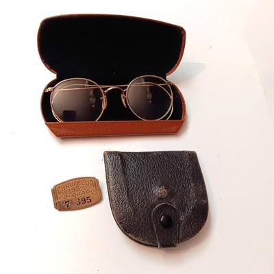 OLD GLASSES IN A CASE, 1952 CHAUFFEUR BADGE AND A COIN PURSE