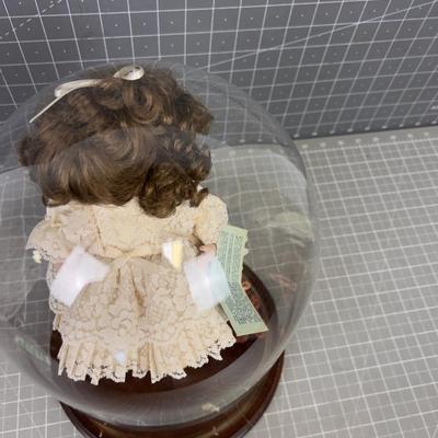 Porcelain Doll under Glass Bell