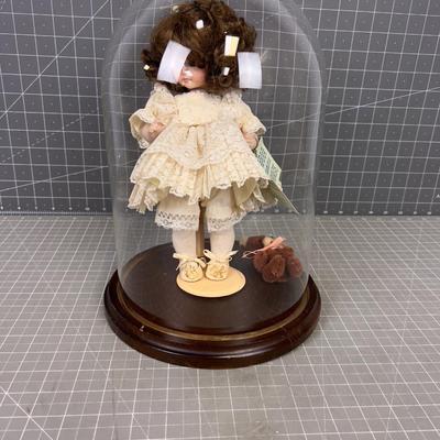Porcelain Doll under Glass Bell
