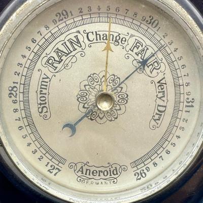 Sale Photo Thumbnail #316: Thermometer and barometer in a beautiful Mahogany case. Working condition. Approx. 11" tall. For hanging on a wall. Age unknown, possibly made in West Germany.