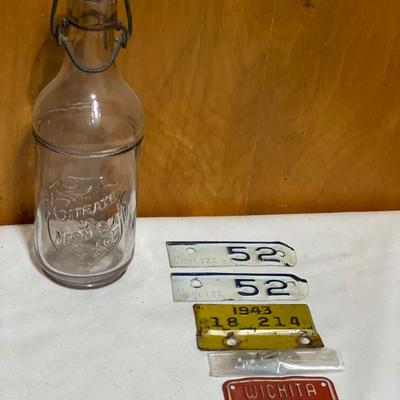 Vintage bottle and small bicycle licenses