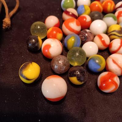 VERY OLD MARBLES AND A LEATHER DRAWSTRING BAG