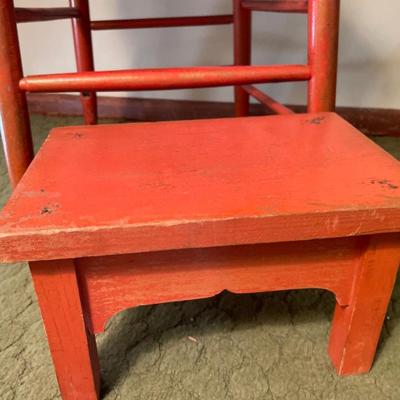 Red foot stool and chair with fall theme blanket