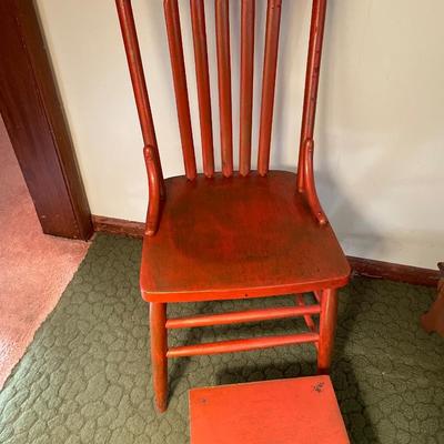 Red foot stool and chair with fall theme blanket