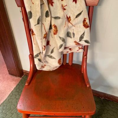 Red foot stool and chair with fall theme blanket