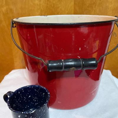 Red enamel bucket and blue speckled cup