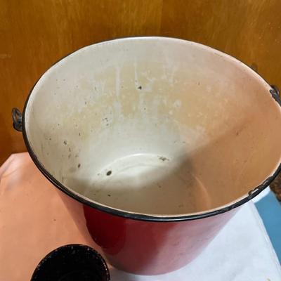 Red enamel bucket and blue speckled cup
