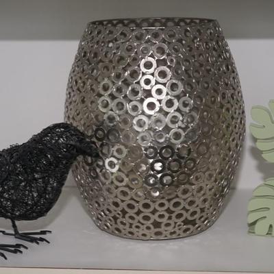 Decorative grouping of a waste can made of small metal circles, a wire crow sculpture and a