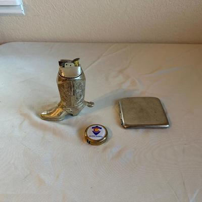 WESTERN BOOT TABLE LIGHTER, CIGARETTE CASE AND A MEASURING TAPE