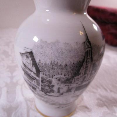 Small bud vase with cityscape on it