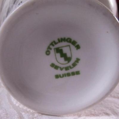 Small bud vase with cityscape on it
